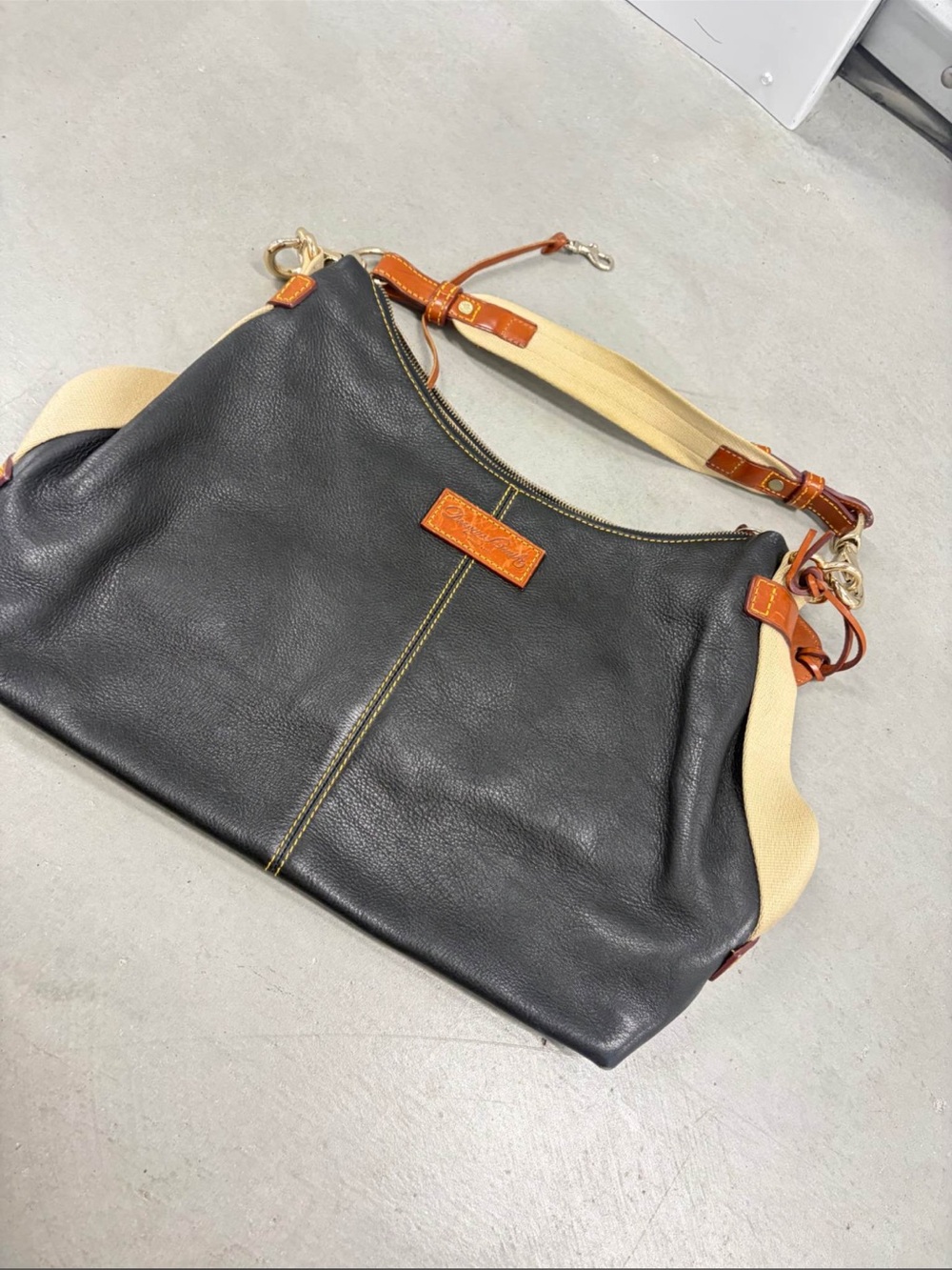 Dooney & Bourke Black Leather Shoulder Bag with Tan Trim and Cream Strap